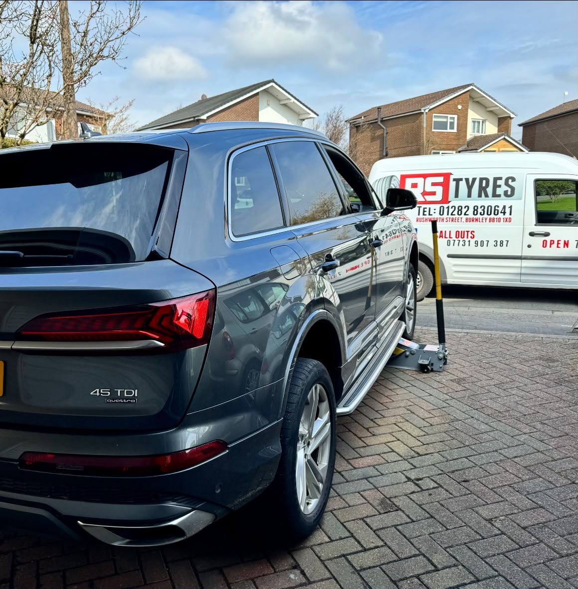 Audi Q7 up on the jack beside the RS Tyres van — mobile tyre callout