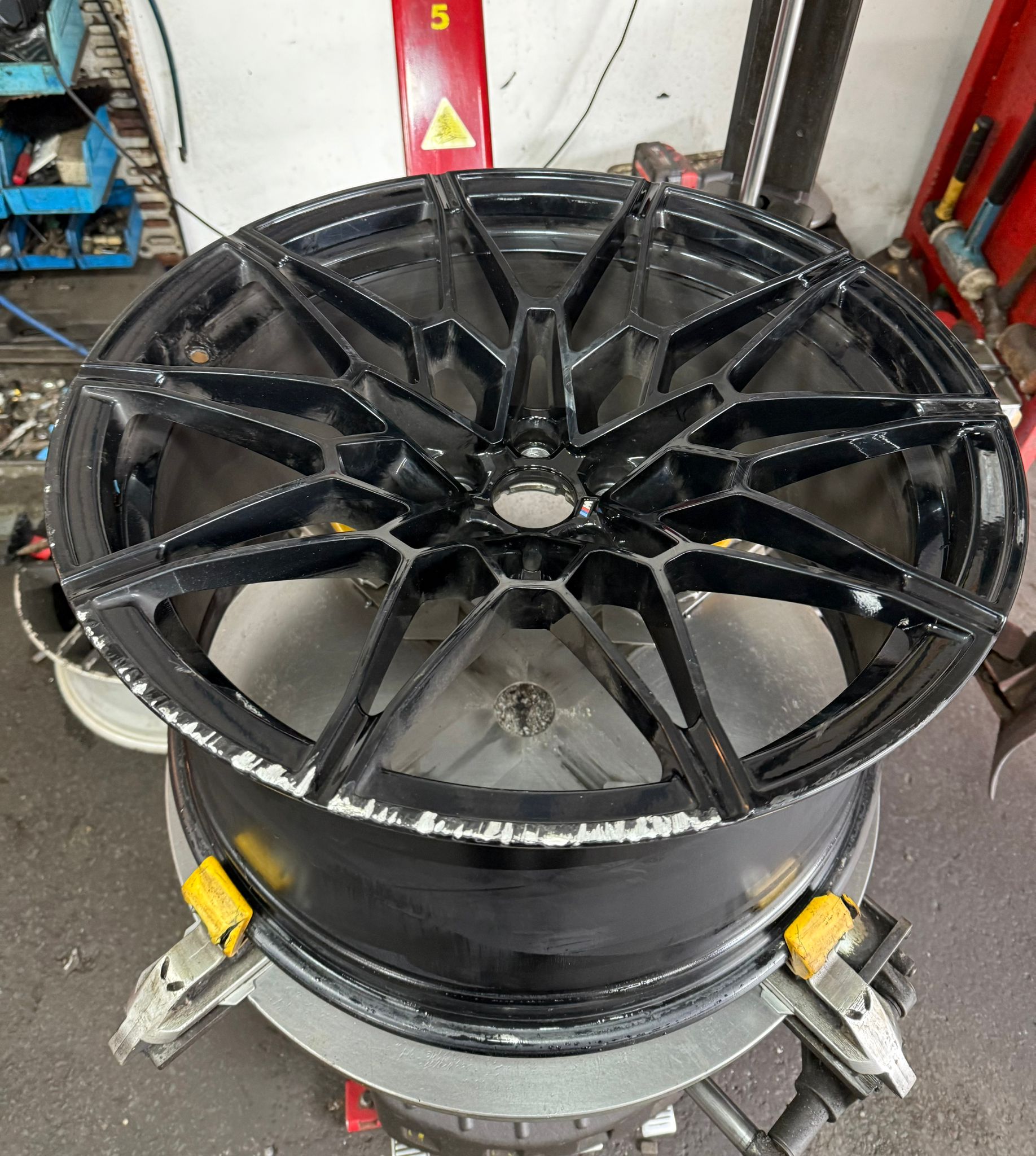 BMW alloy freshly powder-coated in gloss black — Burnley