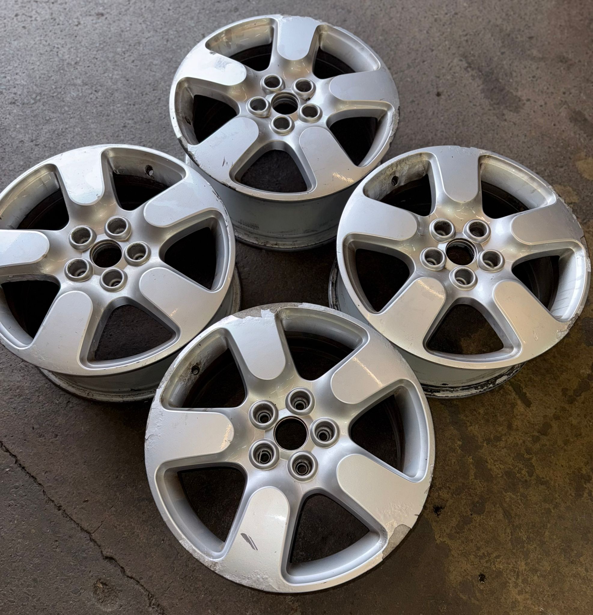 Before — A tired, scuffed set of four brought back to a clean factory-silver finish. — Burnley